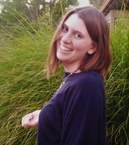 Rachael stands outside smiling
